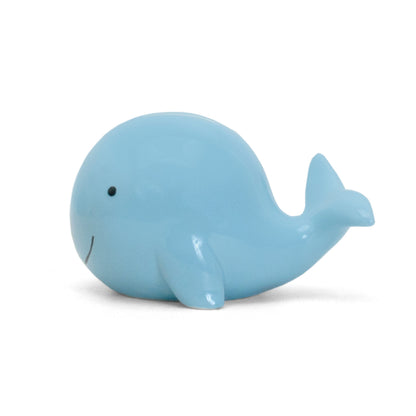 Right side profile of glossy blue whale piggy bank on white background