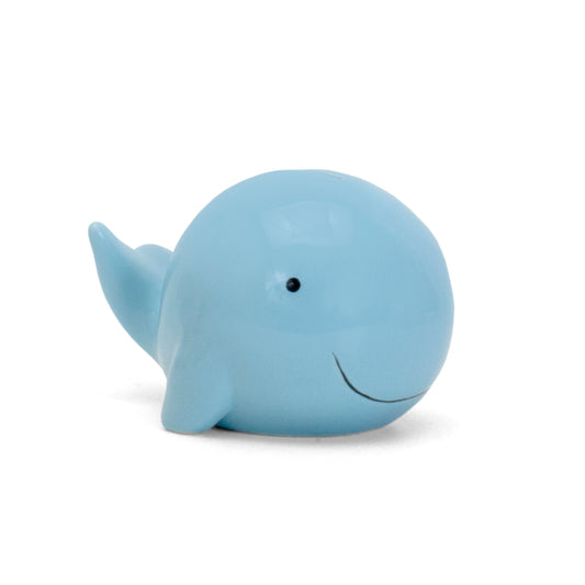 Side view of blue whale ceramic piggy bank with smiling face
