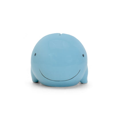 Front view of blue whale piggy bank with black eyes and smile
