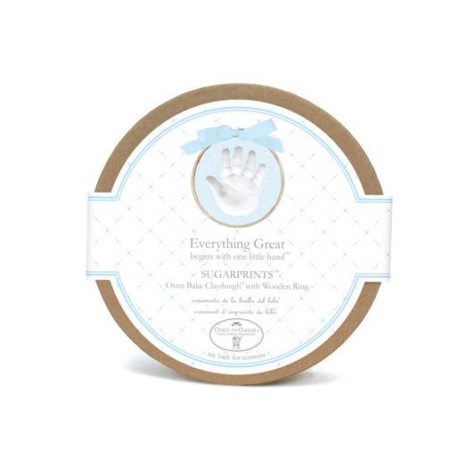 Sugarprints Glitter Handprint Kit round cardboard packaging with blue and white label featuring handprint image and blue ribbon