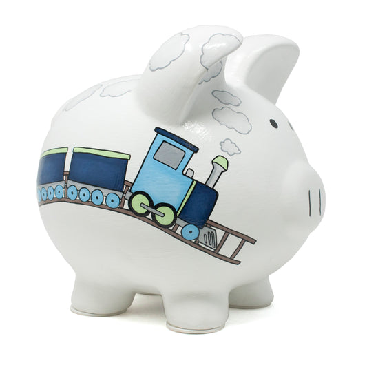 Side angled view of white piggy bank with handpainted blue box car train and gray clouds