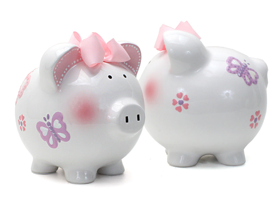Two piggy banks showing front and back with pastel butterflies and pink bows