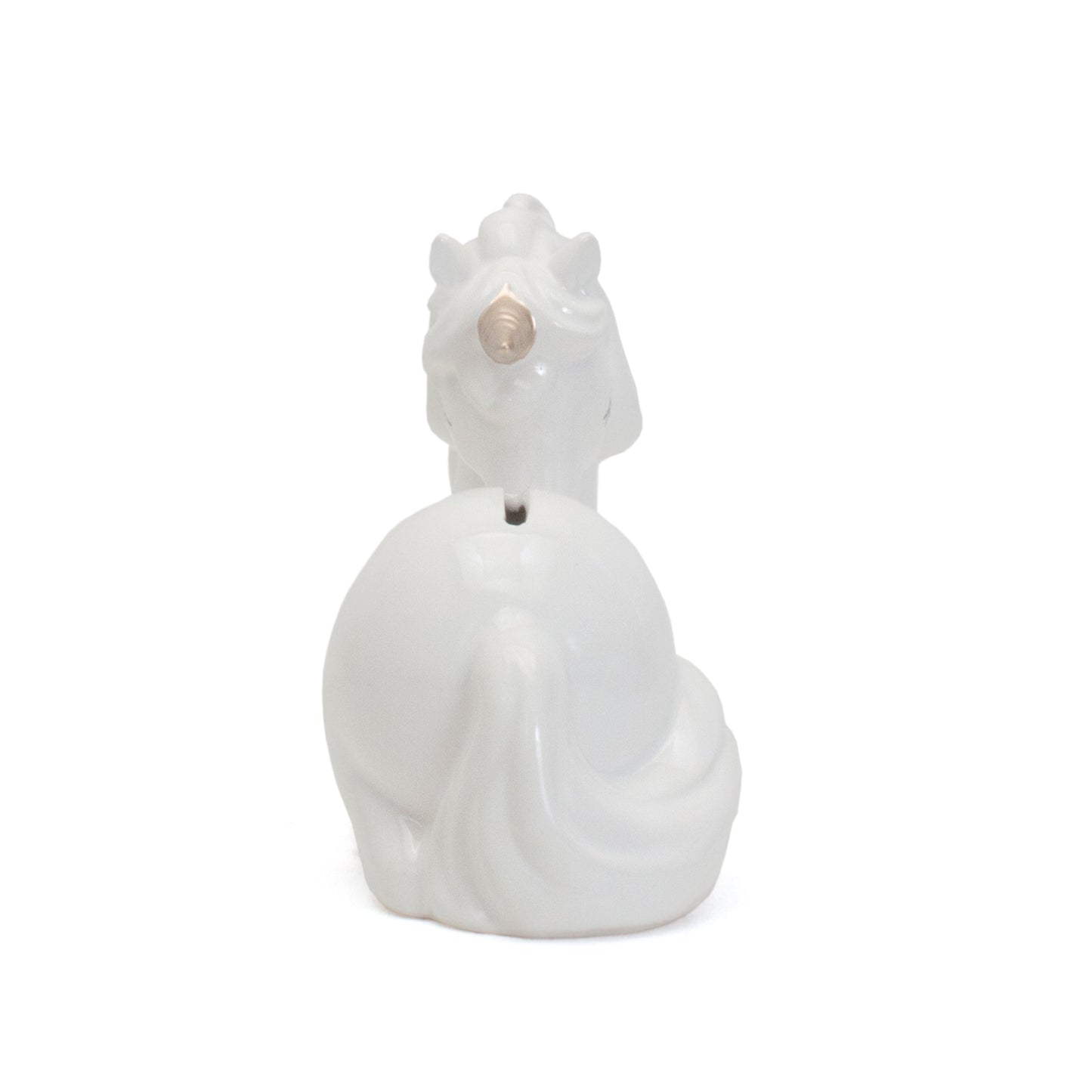Rear view of white unicorn piggy bank displaying coin slot on back