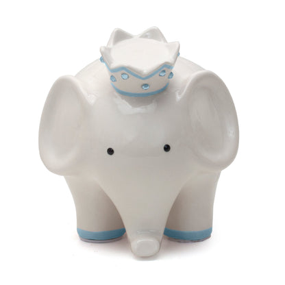 Front view of white ceramic elephant piggy bank with black eyes and blue crown adorned with blue gems