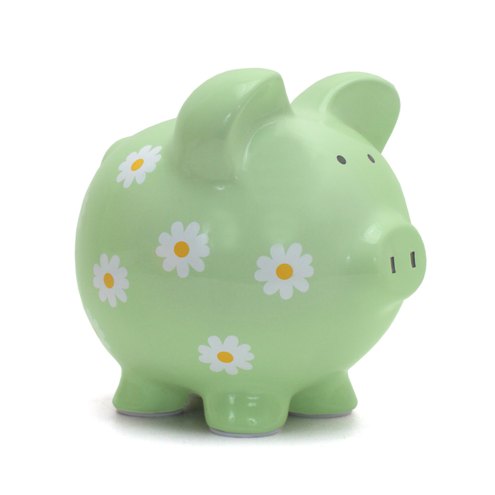 Green ceramic piggy bank with white and yellow daisy patterns, front angle
