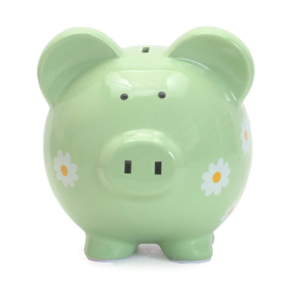 Back view of green piggy bank showing detailed daisy designs and sturdy feet