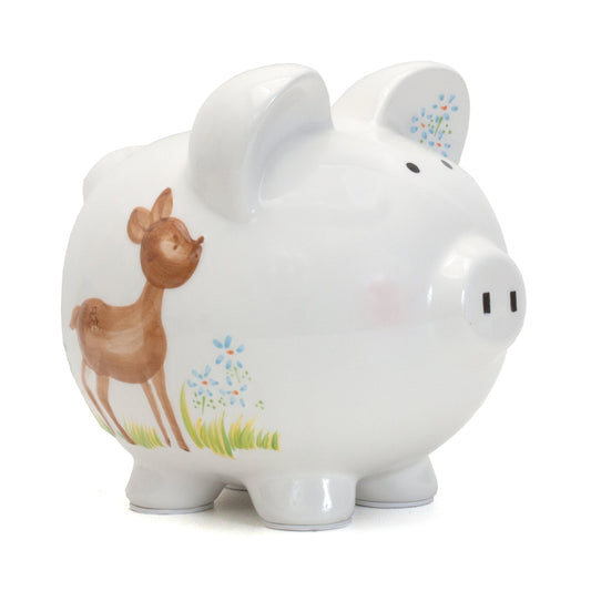 Side view of white ceramic piggy bank featuring a handpainted brown deer and blue flowers