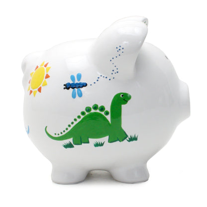 Side view displaying smiling green dinosaur and flying dragonfly on ceramic piggy bank