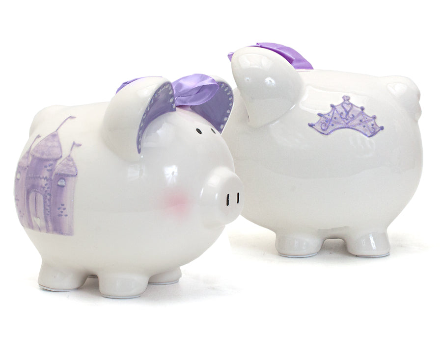 Twin view of front and back of white piggy bank with lavender crown and castle details and purple bow