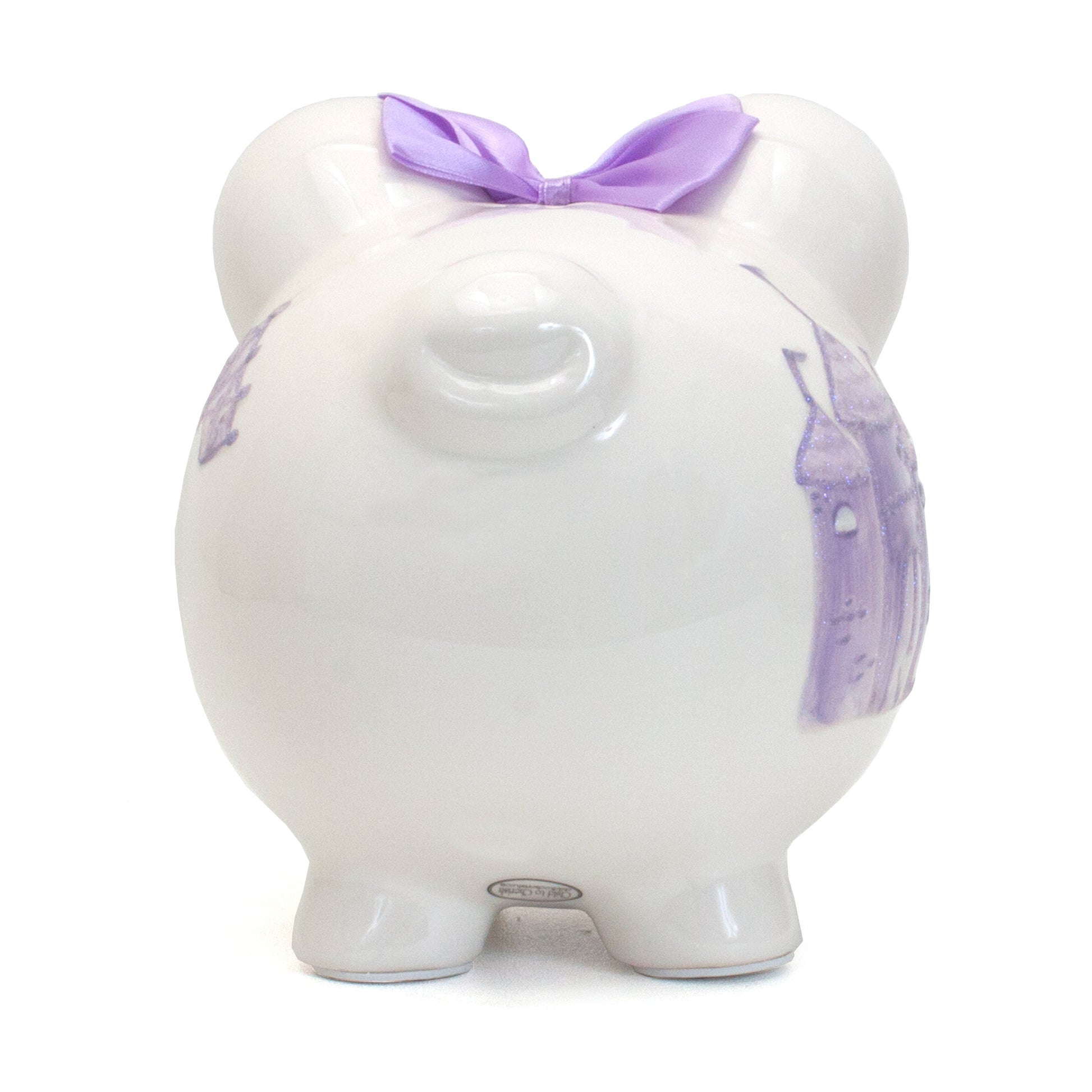 Back side view of white ceramic piggy bank with lavender castle and purple satin bow on top