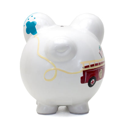 Close-up front view of a white ceramic piggy bank with minimalist black eyes and nostrils on snout