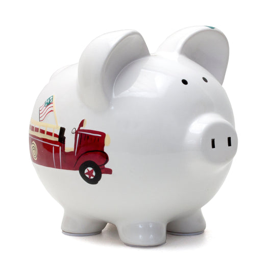 White ceramic piggy bank in shape of a pig with red firetruck and American flag painted on the side