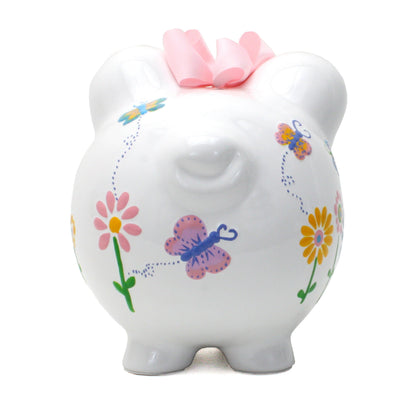 Front view of floral decorated ceramic piggy bank showing butterfly details and pink bow