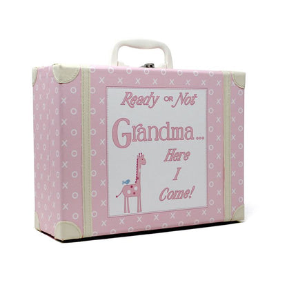 Angled side view of pink children's suitcase with white XO pattern and stitched white corners
