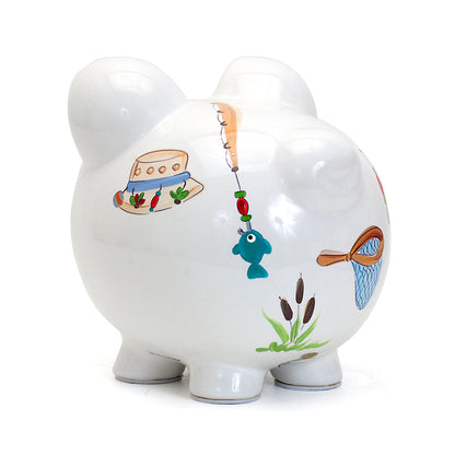 side view of white piggy bank highlighting fishing rods and cattail plants design