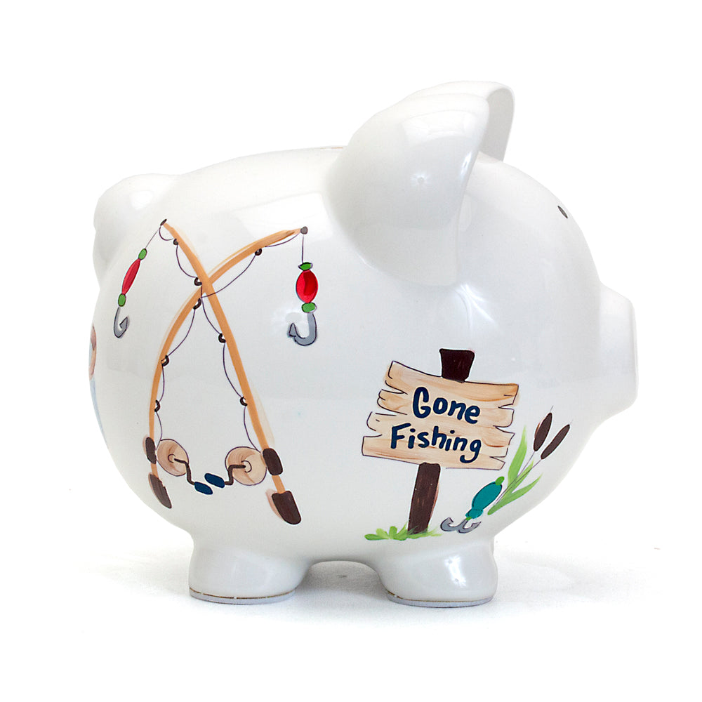 angle view of white ceramic piggy bank with fishing theme handpainted details
