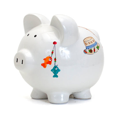 side view of fishing hat and fish hooks painted on white ceramic piggy bank