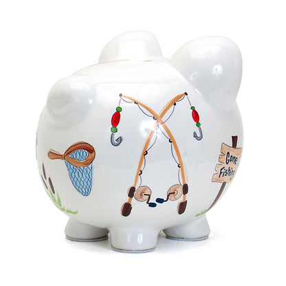 two white ceramic piggy banks side by side with gone fishing handpainted theme