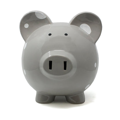 Front view of gray polka dot ceramic piggy bank showing coin slot and snout