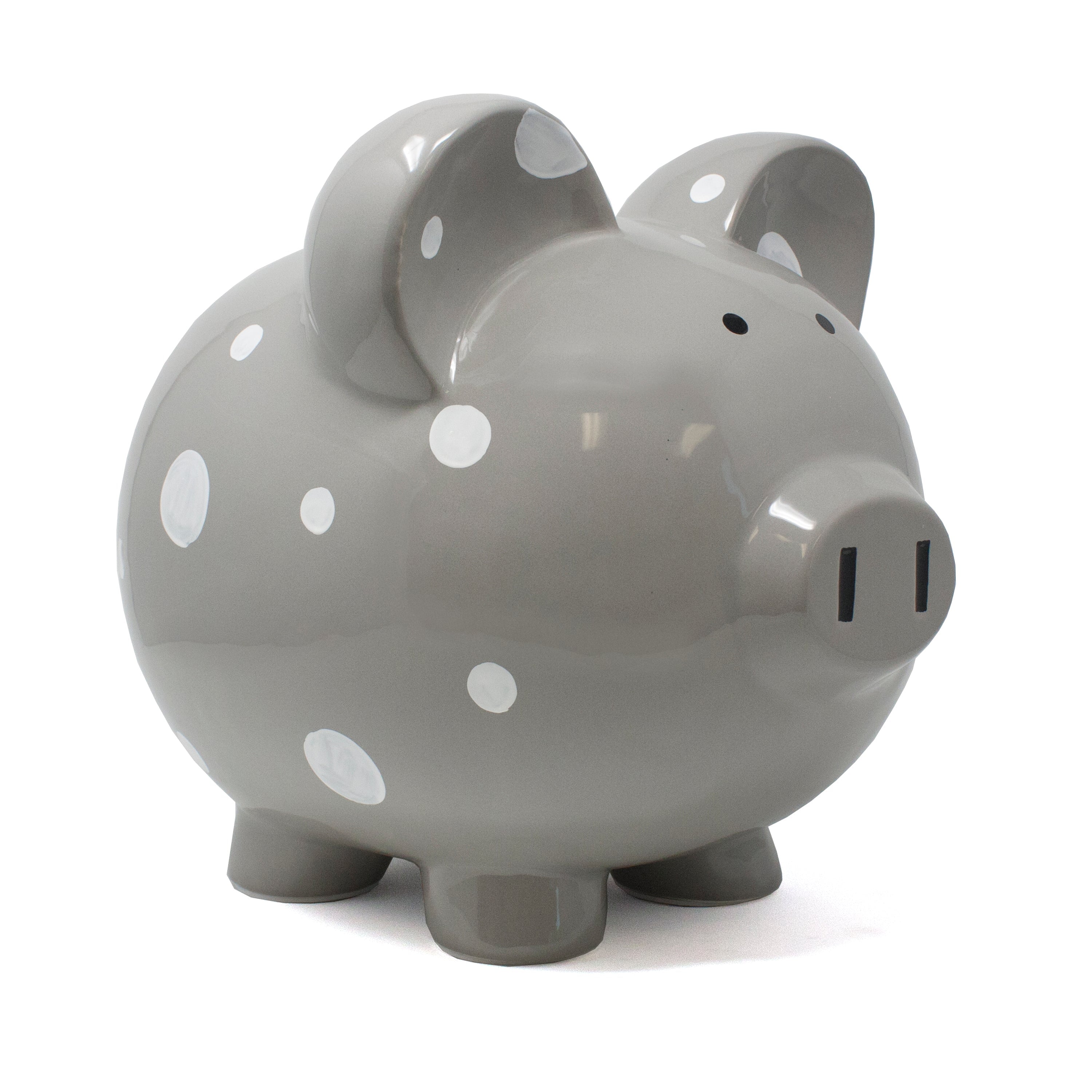 Side view of gray ceramic piggy bank with white polka dots