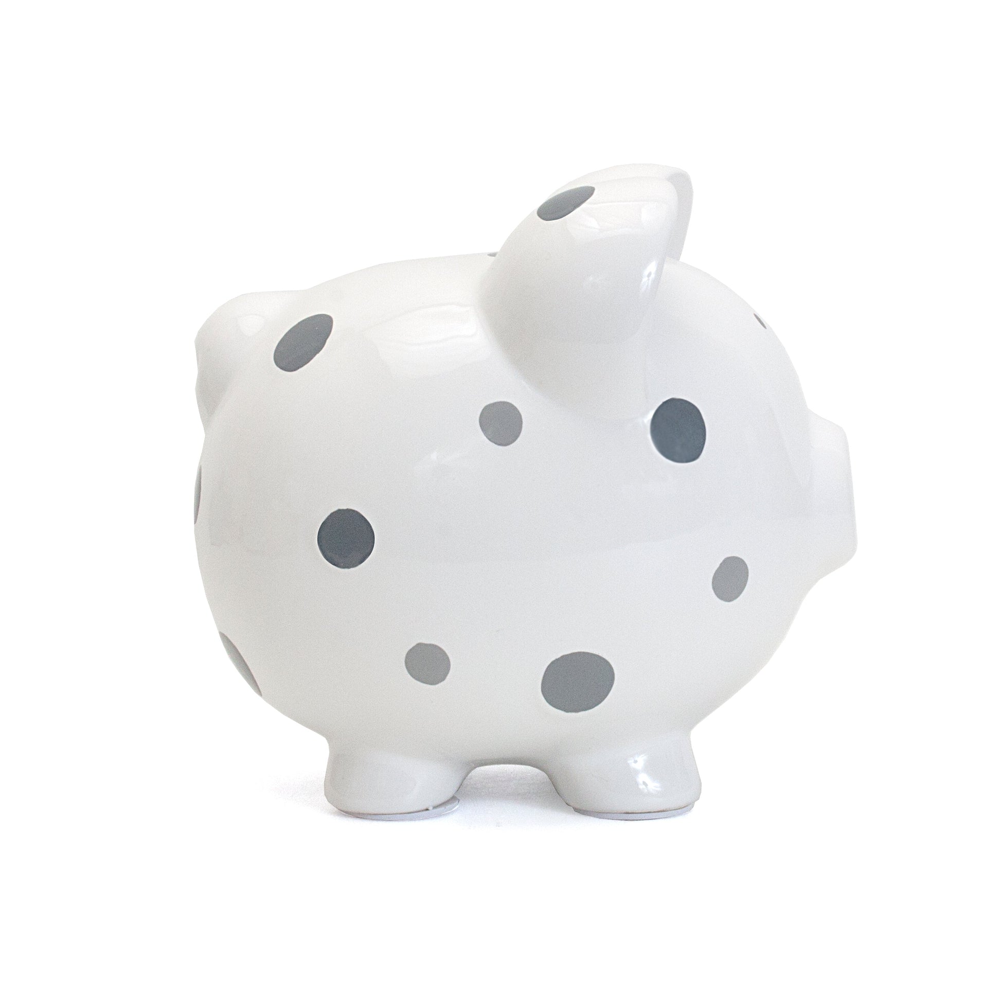Side view showing the round shape and polka dot pattern of the piggy bank