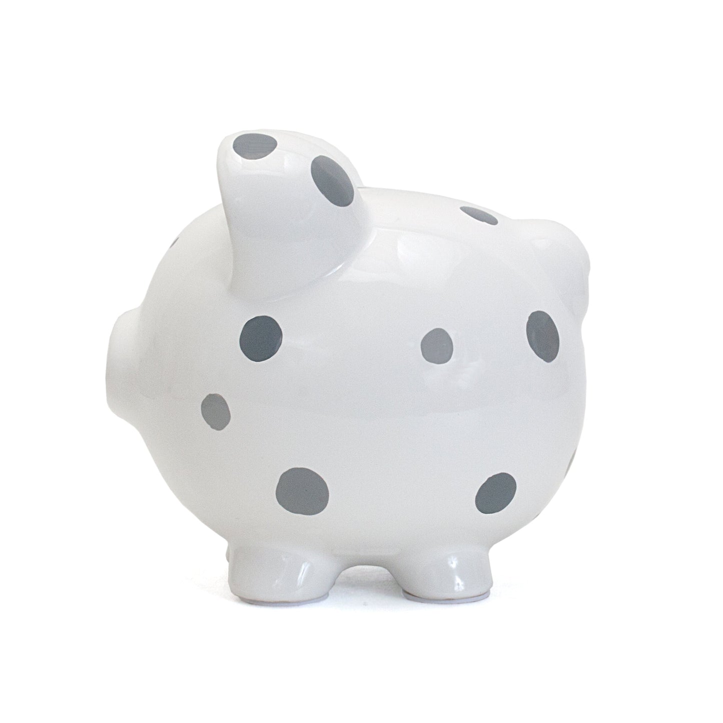 Side view displaying the piggy bank's smooth glossy finish and polka dots