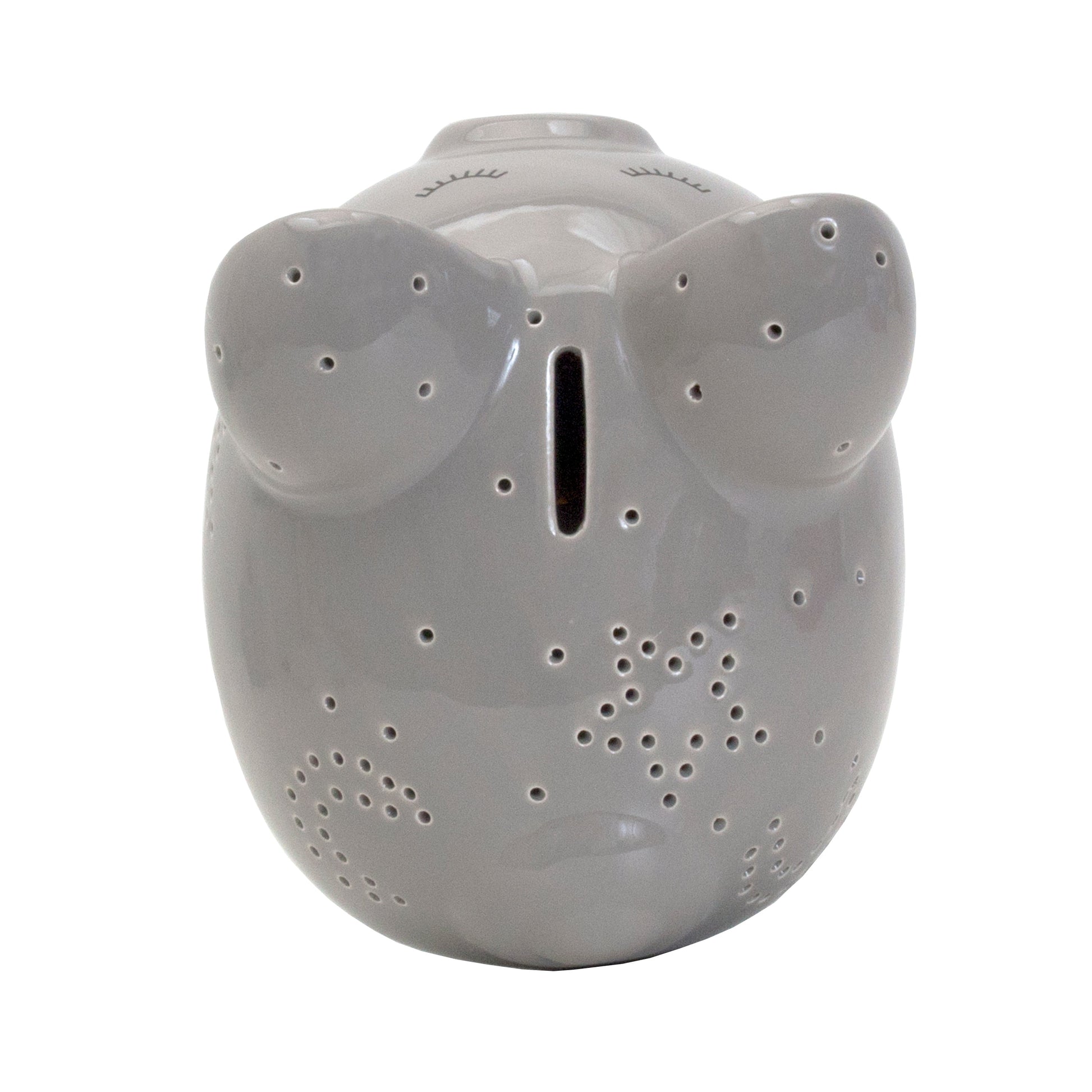 Top view of gray ceramic pig showing coin slot and star perforations
