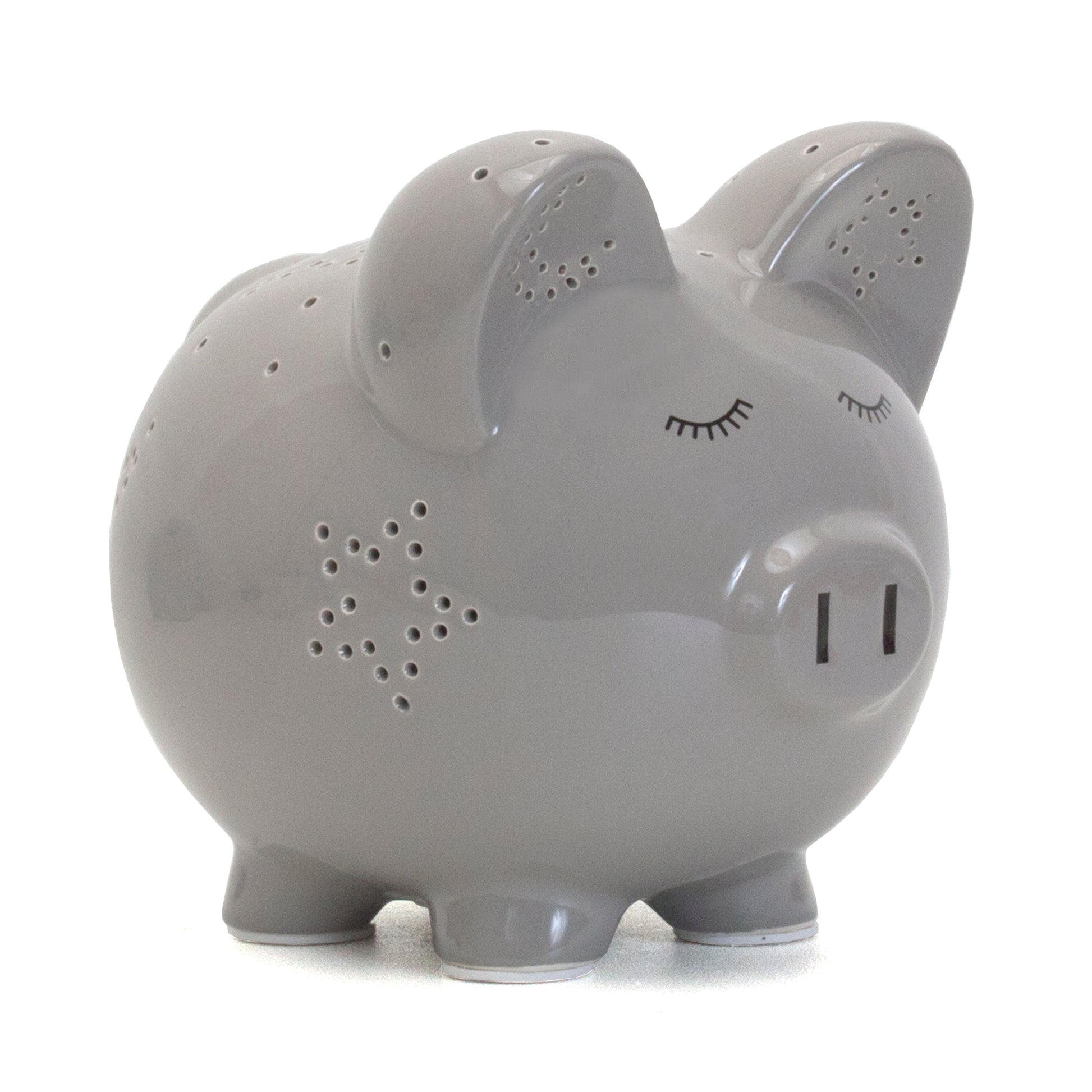 Gray ceramic pig piggy bank with closed-eye face and star-shaped perforations