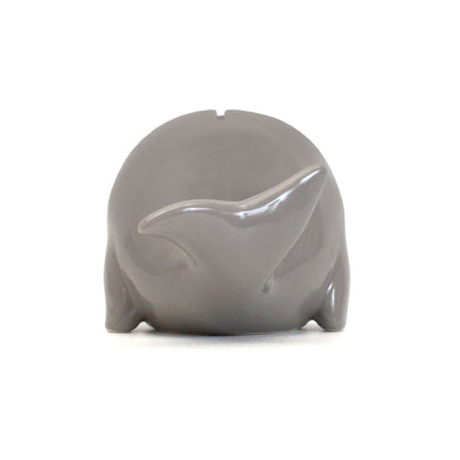 Gray ceramic whale piggy bank back view showing tail and coin slot