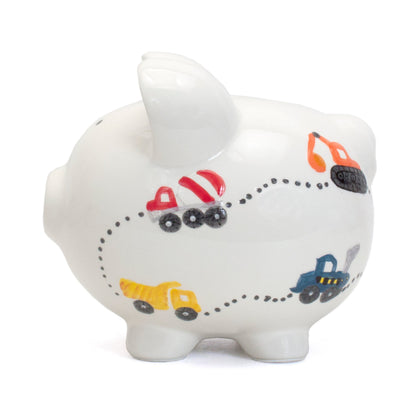 Side view highlighting multiple construction vehicle designs on white piggy bank