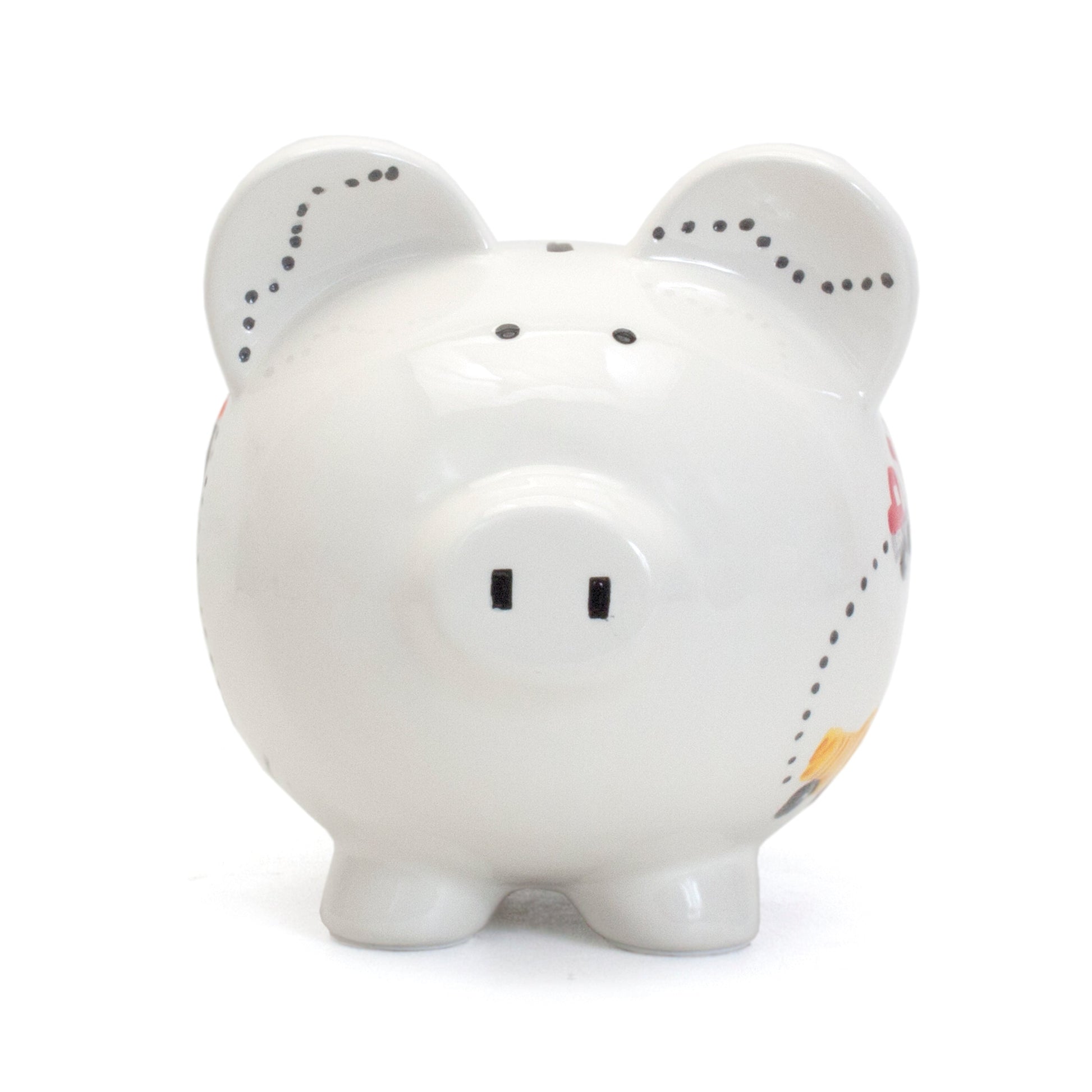 Front view of white ceramic piggy bank with simple black eyes and snout markings