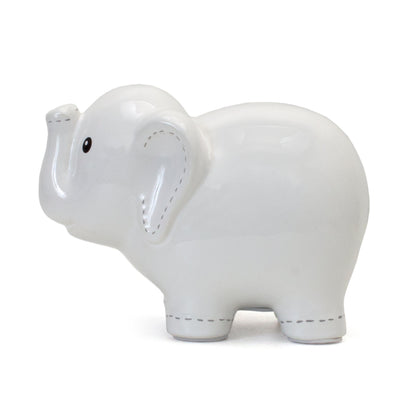 Close-up of white stitched elephant bank with coin slot on top