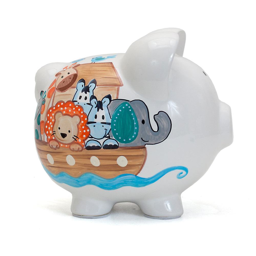 Side view of white ceramic piggy bank showing handpainted wooden ark with giraffe, lion, and elephant
