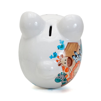 Top view of white ceramic piggy bank showing coin slot and part of handpainted animal design