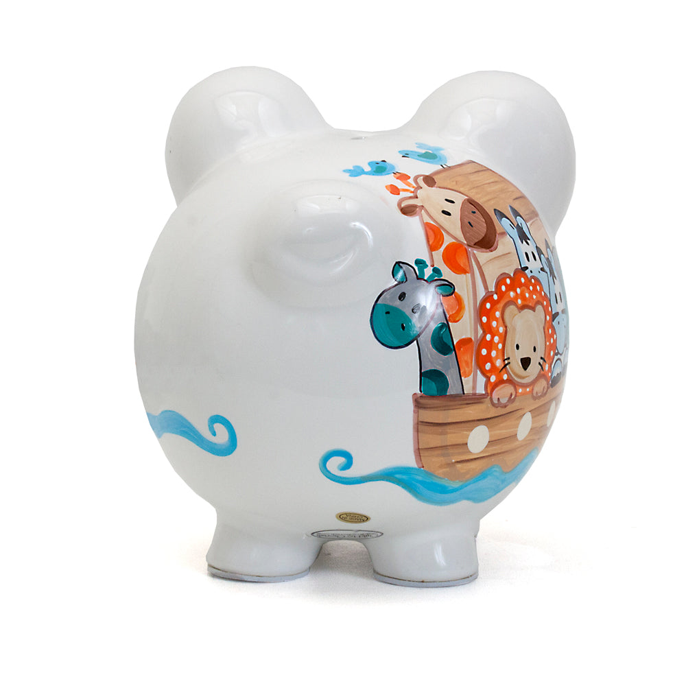 Back side of white ceramic piggy bank with giraffe, cow, lion, zebra, and boat handpainted design