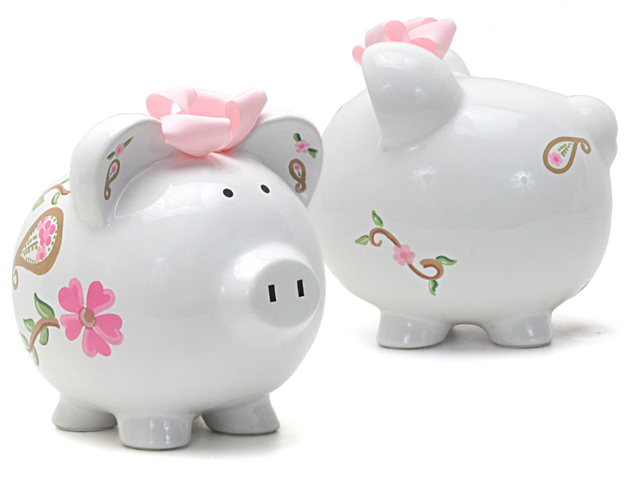 Front and back views of white ceramic piggy bank featuring handpainted pink bow, paisley, and floral patterns