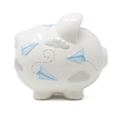 Close-up of front side of piggy bank showing nose, eyes, and painted airplanes and clouds