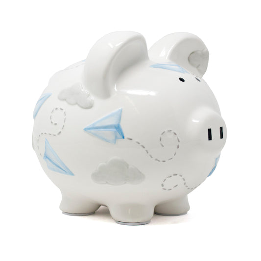 White ceramic piggy bank with blue paper airplane and gray cloud handpainted design angled left