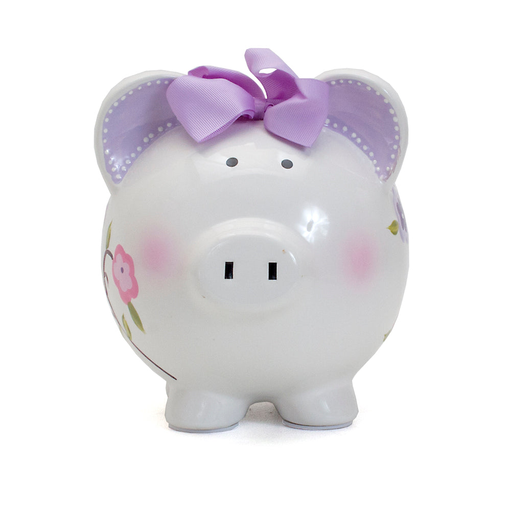Front view of white bird-themed piggy bank with lavender bow and pink blush on cheeks