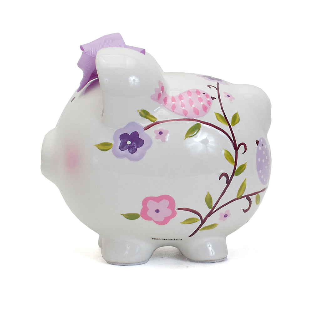 Opposite side of piggy bank showing more bird and flower artwork with lavender ear interior