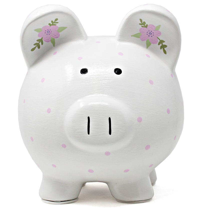 Close-up front view of white piggy bank with painted black eyes, nose, and pink polka dots