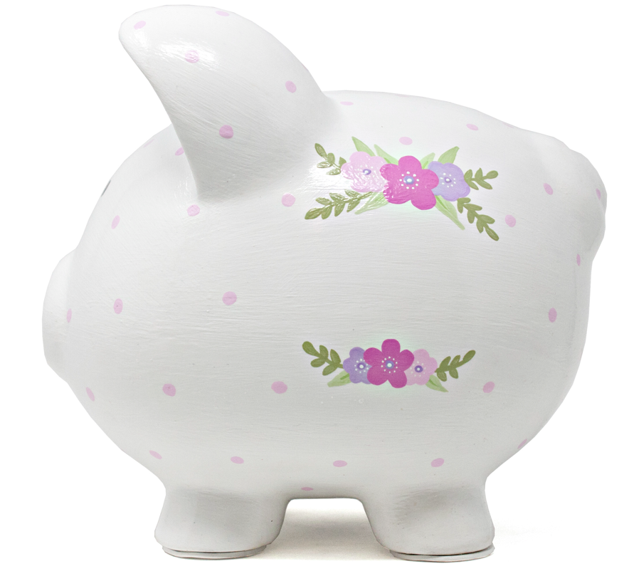 Side view of pink polka dotted white piggy bank with purple and pink flowers painted on the back