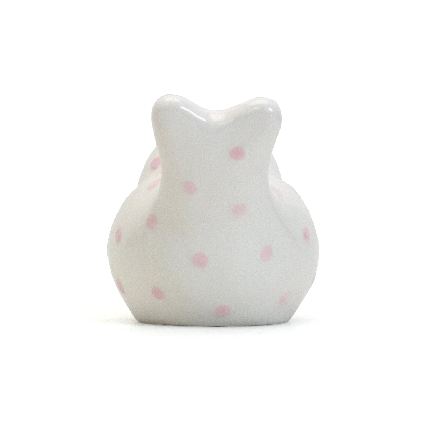 Back view of white ceramic bird piggy bank showing pink polka dots