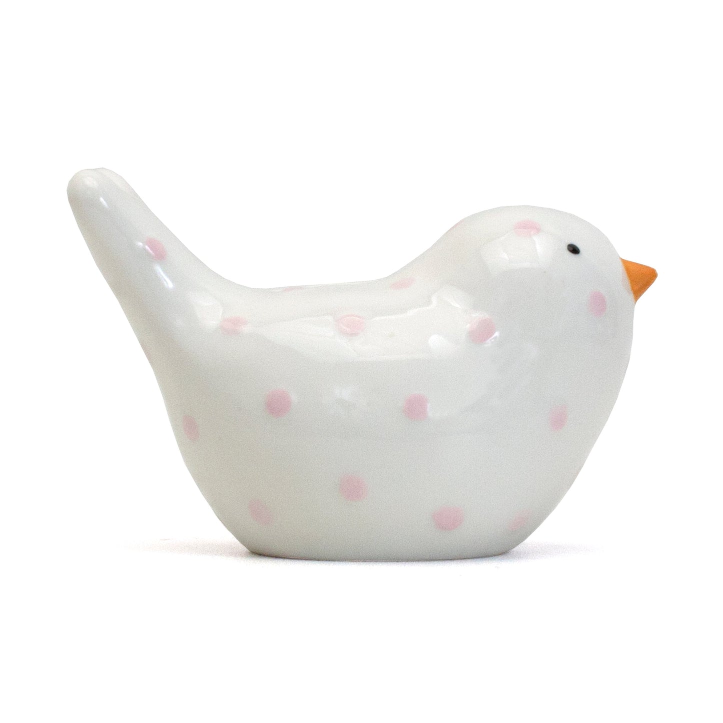 Left side view of white ceramic bird piggy bank with pink polka dots
