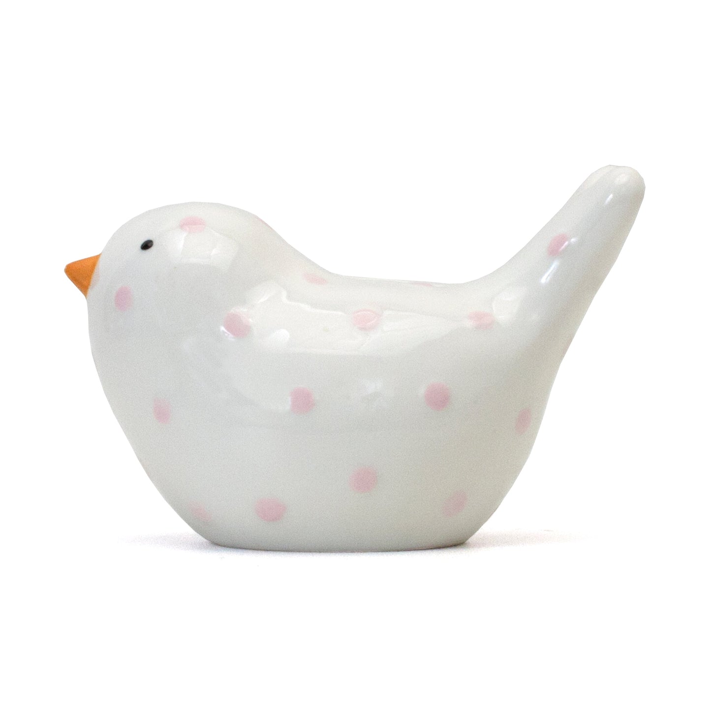 Right side view of white ceramic bird piggy bank with pink polka dots