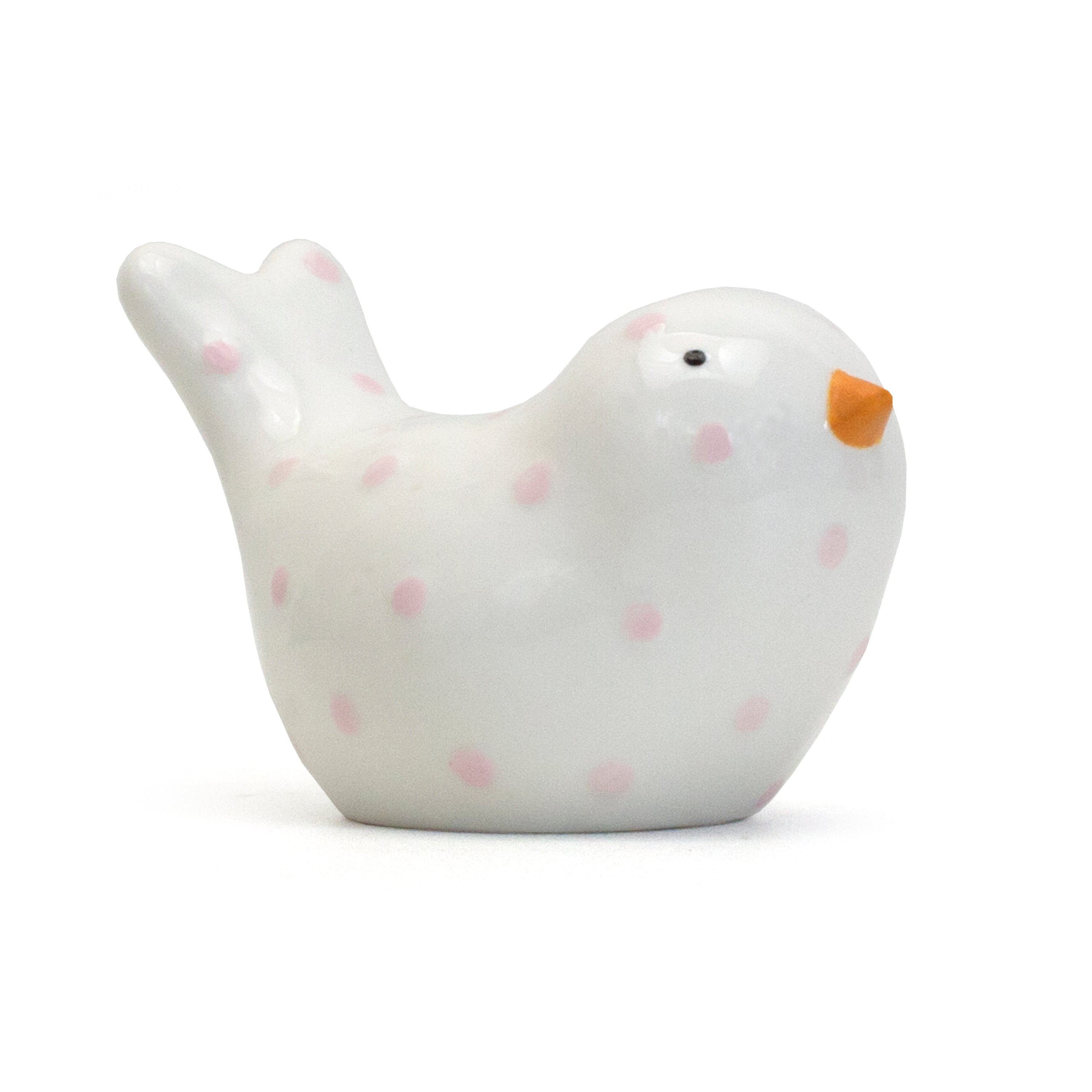 Side view of white ceramic bird piggy bank with pink polka dots and orange beak