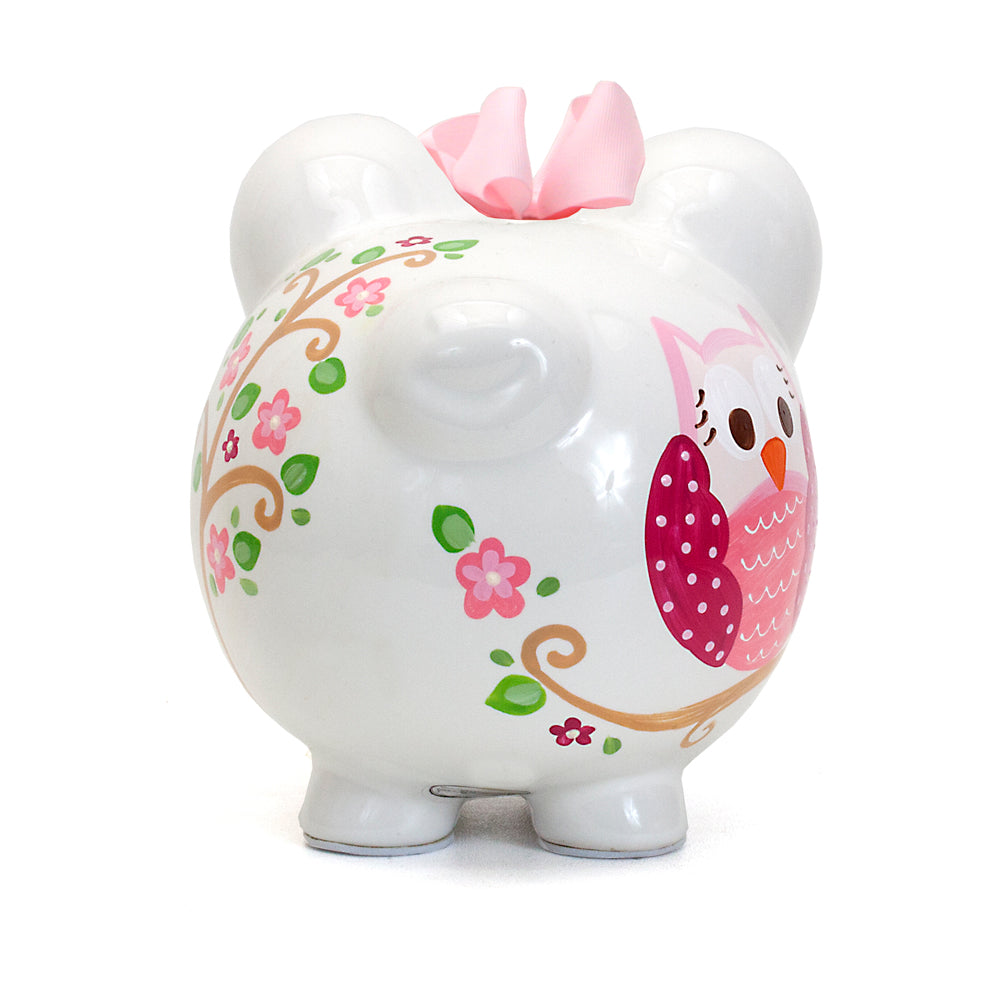 Back side of pink owl piggy bank showing floral design and pink bow