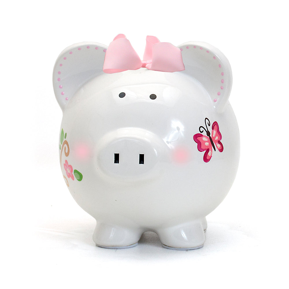 Front view of white ceramic piggy bank with pink bow and butterfly detail