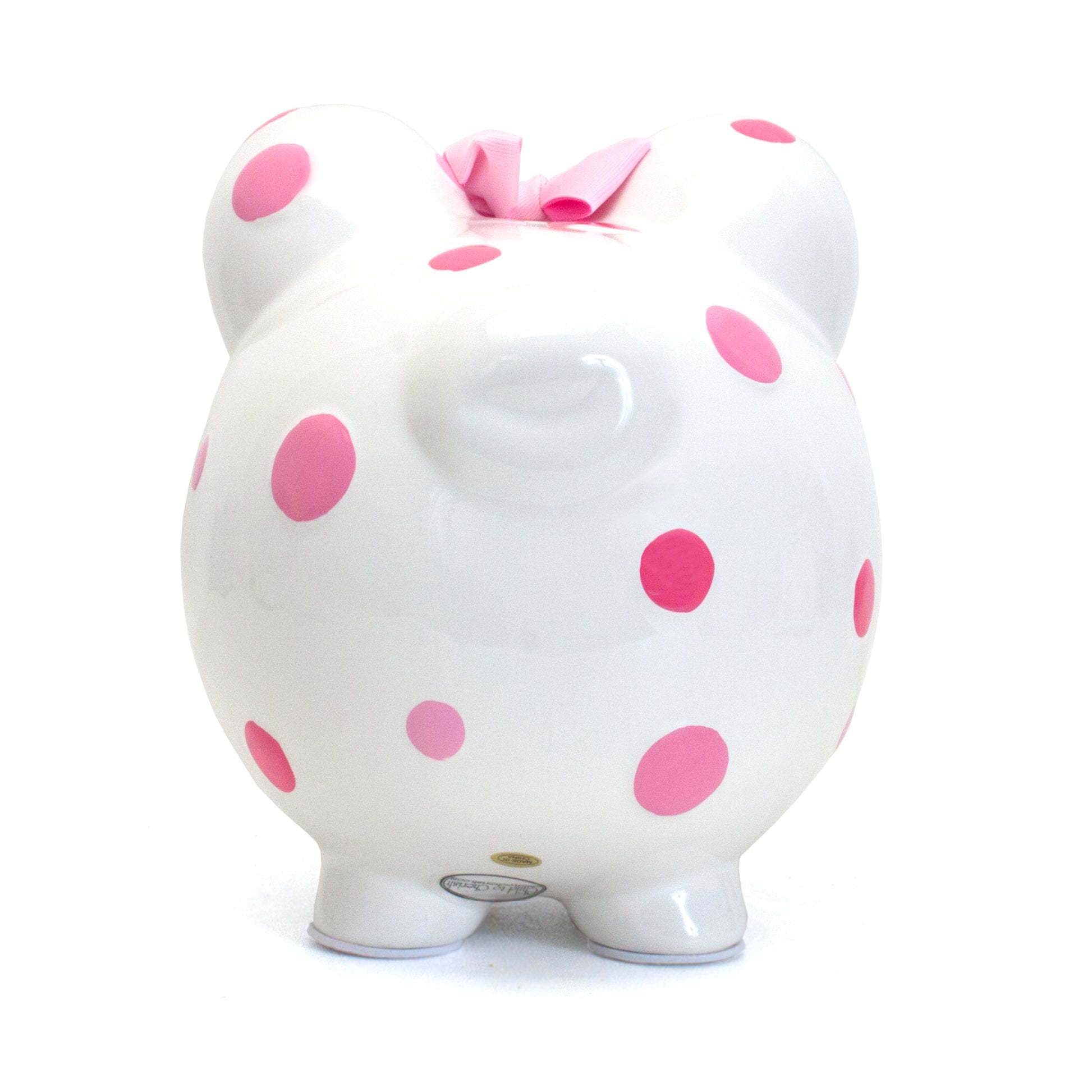 Top angle showing coin slot on white piggy bank with pink polka dots and pink bow