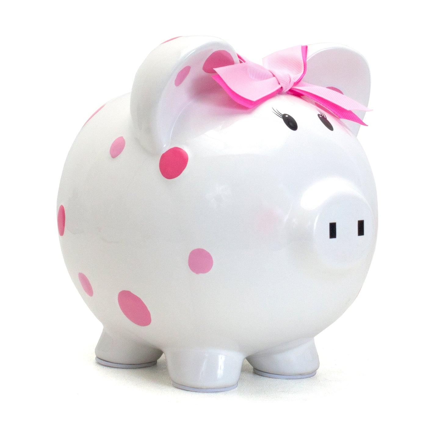 White ceramic piggy bank with pink polka dots and pink bow on ear, side angle view